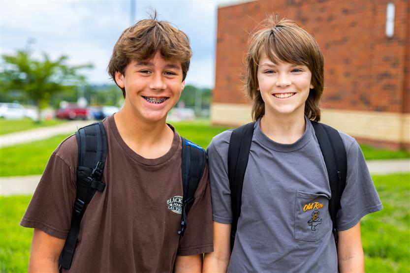 Two students smile